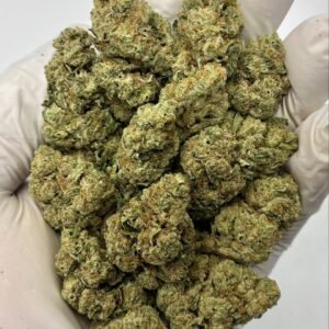 Banana OG THCa Flower close-up – frosty, dense nugs with vibrant pistils and trichomes